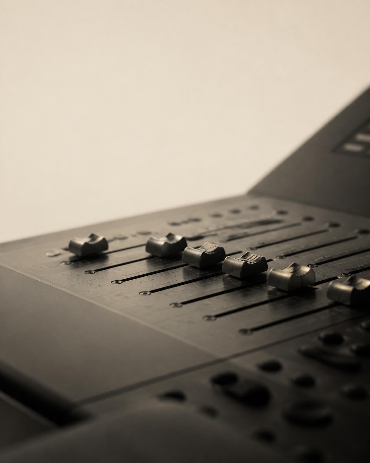 Close-up of faders on a professional audio mixing console